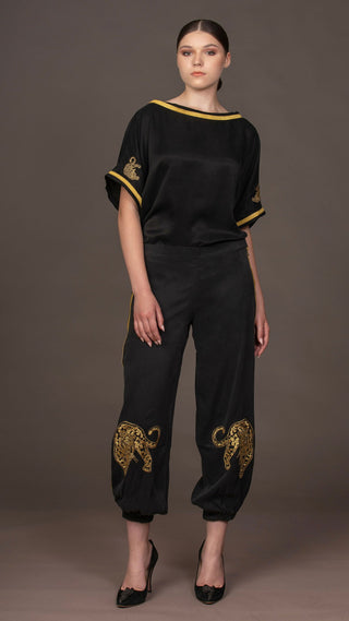 woman wearing a modern black designer outfit with golden leopard embroideries from #Mary and Mary#