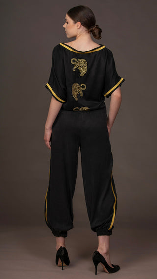 woman wearing a modern black designer outfit with golden leopard embroideries  from #Mary and Mary#