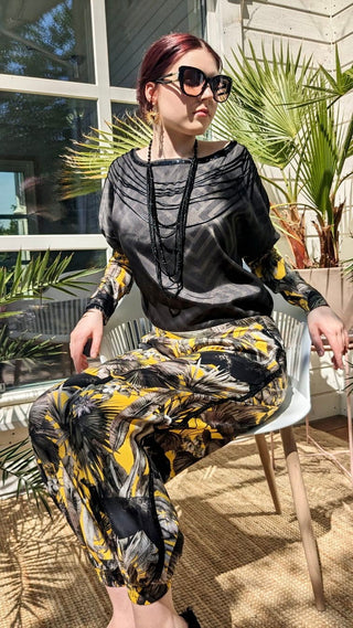 woman wearing a modern designer outfit printed with yellow jungle design and  luxury details from #Mary and Mary#