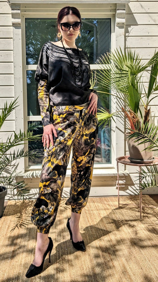 woman wearing a modern designer outfit printed with yellow jungle design and  luxury details from #Mary and Mary#