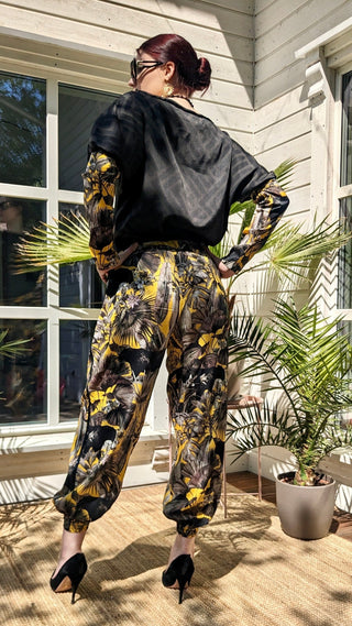 woman wearing a modern designer outfit printed with yellow jungle design and  luxury details from #Mary and Mary#