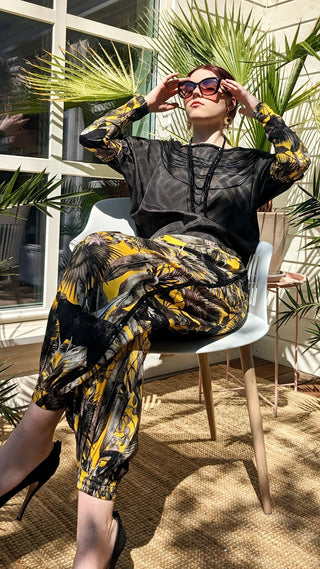 woman wearing a modern designer outfit printed with yellow jungle design and  luxury details from #Mary and Mary#