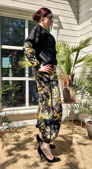 woman wearing a modern designer outfit printed with yellow jungle design and  luxury details from #Mary and Mary#